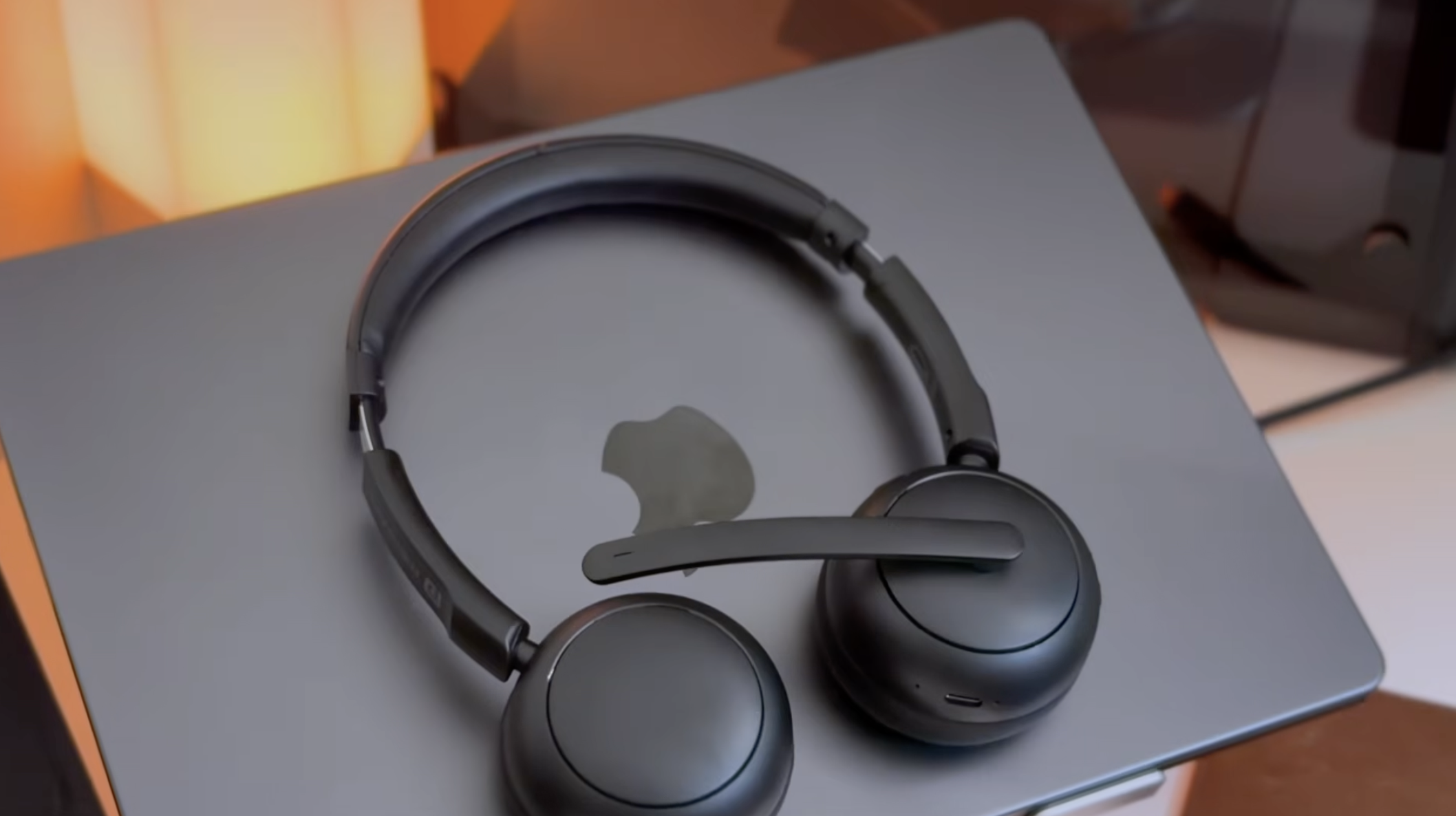 Portronics Muffs A3 placed on a MacBook — seamless pairing with laptops